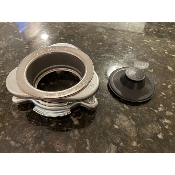 Insinkerator garbage disposal flange with stopper