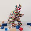 Multi Striped Knitted T Rex Dinosaur Soft Toy. Suitable from Birth
