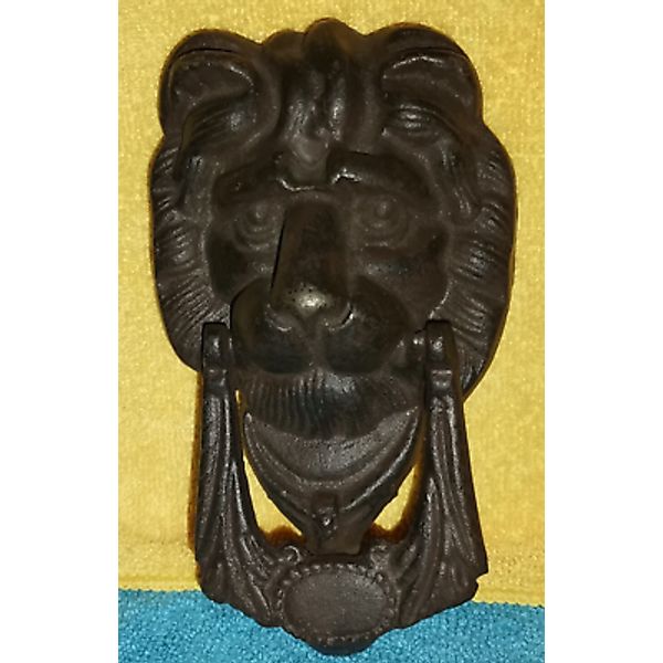 Antique door knocker, made of iron, lion head