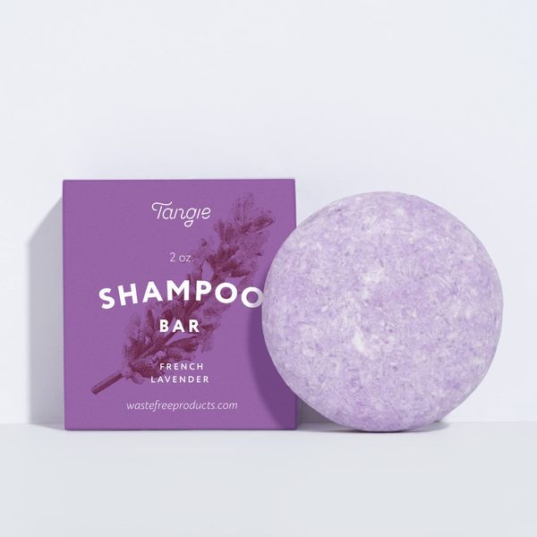 Natural Lavender Solid Shampoo Bar by Tangie. Lasts 50+ washes. Made in Florida, USA. Paper packaging is recyclable and compostable.