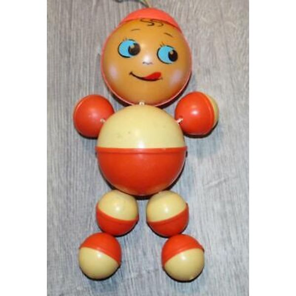 Large Figural Celluloid Baby Rattle Orange and Yellow Boy Side Glancing Eyes 10"